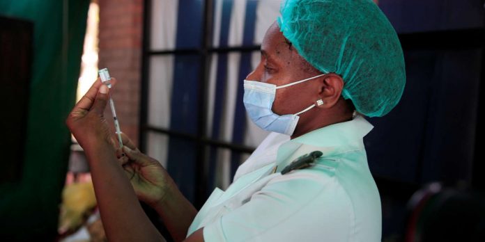 FILE PHOTO: A nurse prepares a dose of the Sinopharm coronavirus (COVID-19) vaccine at Wilkins hospital in Harare